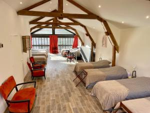 a room with four beds and a room with a room at La Sorga - gîte 12 personnes in Blesle