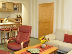 a living room with a couch and a table at Apartment Wiesengrund by Interhome in Neuhaus am Rennweg