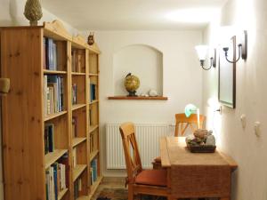 a dining room with a table and book shelves at Apartment Wiesengrund by Interhome in Neuhaus am Rennweg