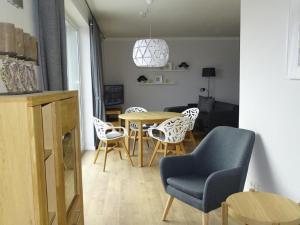 a living room with a table and chairs at Apartment Wünnowblick by Interhome in Röbel