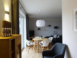 a living room with a table and chairs at Apartment Wünnowblick by Interhome in Röbel