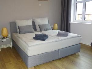 a bed with two pillows on it in a bedroom at Apartment Wünnowblick by Interhome in Röbel
