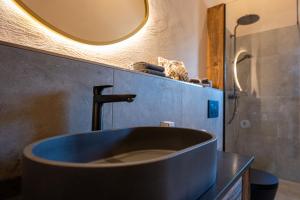 a bathroom with a large blue sink and a mirror at Bomwäldele 89 in Bichlbach +22 photos