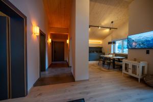 a living room with a table and a dining room at Bomwäldele 89 in Bichlbach