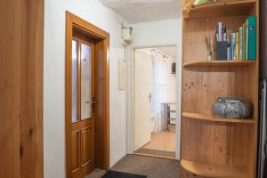 a hallway with a door and a camera on a shelf at Apartment Jursport in Závažná Poruba +53 photos