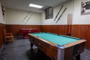 a room with a pool table and bats on the wall at Hotel Hipic in Vielha
