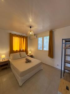 a bedroom with a large bed and a window at Villa Altura in Rivière-Salée +15 photos