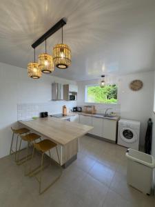 a kitchen with a table and some chandeliers at Villa Altura in Rivière-Salée