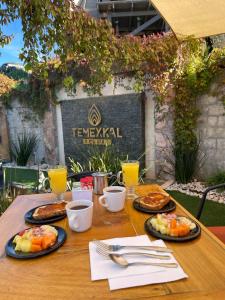 a wooden table with plates of food on it at TEMEXKAL RESORT in Ensenada