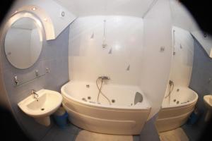 a bathroom with a tub and a sink and a bath tub at Apartment on Lenina 7a in Svetlogorsk