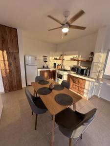 a kitchen with a table and chairs in a room at Bed and Cactus - Ocean View Villa in El Sargento