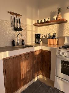 a kitchen with a sink and a stove at Bed and Cactus - Ocean View Villa in El Sargento