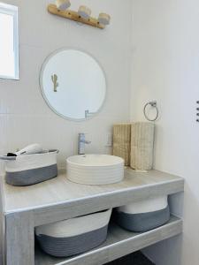 a bathroom with a sink and a mirror at Bed and Cactus - Ocean View Villa in El Sargento