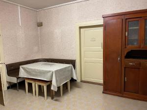 a room with a table and a cabinet and a door at L'Envolée - Spacieux, 2 personnes in Horbourg