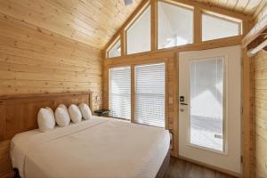 a bedroom with a bed in a wooden room at Page Lake Powell Campground - Tiny Home King Room in Page