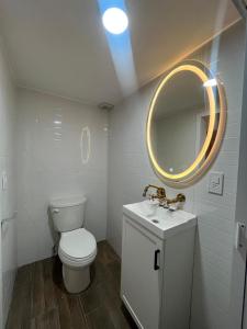 a bathroom with a toilet and a sink and a mirror at Apartamento 25 Centrico Chapala in Chapala