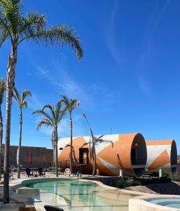 a resort with a swimming pool and palm trees at TEMEXKAL RESORT in Ensenada