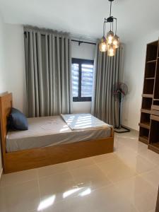 a bedroom with a bed in front of a window at loved modern home 2BR in New cairo