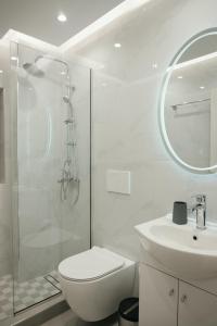 a bathroom with a toilet and a sink and a shower at Rhodes Central Apartment in Rhodes Town +26 photos