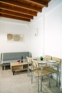 a dining room with a table and chairs and a couch at Rhodes Central Apartment in Rhodes Town