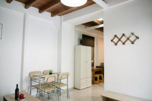 a kitchen and dining room with white walls and a table and chairs at Rhodes Central Apartment in Rhodes Town