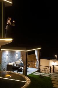 a person standing on top of a building at night at Zeyzid Glamping Sheki in Sheki