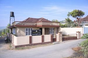 a small house on the side of a road at Moon Glade Cottage, Homestay Coorg, Madikeri in Madikeri