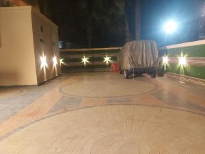 a stage with a chair on the floor at night at Dove INN Express II in Lahore
