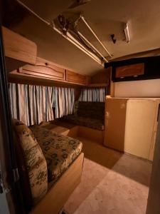 an interior of an rv with a bed and a couch at DSC Family Fun Park in Standerton +17 photos