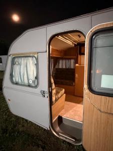 a white van with an open door with a bed at DSC Family Fun Park in Standerton