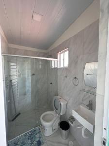 a bathroom with a shower and a toilet and a sink at Mar e Sol Tabatinga in Nísia Floresta +16 photos