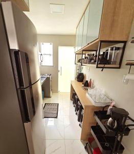 a kitchen with a refrigerator and a counter top at SaltBeach Salinópolis Salt Reserve in Salinópolis +11 photos