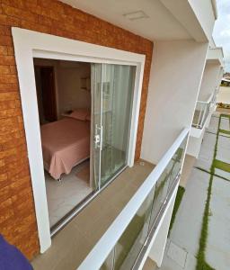 a balcony with a view of a bedroom at SaltBeach Salinópolis Salt Reserve in Salinópolis
