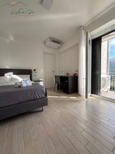 a bedroom with a bed and a desk and a table at La valle del ciglioto in Licusati