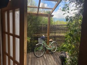 a bike is parked on a wooden deck at Natures Balcony Reclaimed Wood Cabin with Villarrica Volcano and Majestic Peak Views in Pucón
