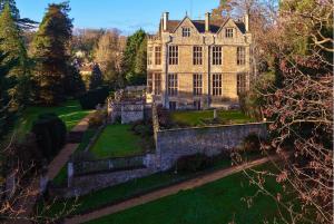 an aerial view of a large house with a garden at The Hall Estate - Historic Grade I-listed Jacobean Mansion in Bradford on Avon