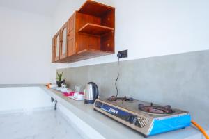 a kitchen counter with a stove and a microwave at Raviru Guest Mirissa in Mirissa +89 photos