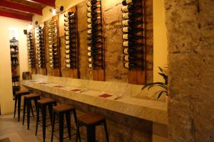 a bar with a row of wine bottles at Don Raffaé in Nola