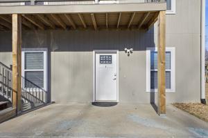 a building with a white door and a porch at Sun Valley Courtyard, No Steps in Saint Joseph