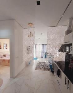a large white room with a bed and a kitchen at Jasmine in Sharm El Sheikh