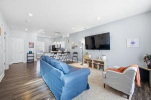 a living room with a blue couch and a tv at Sun Valley Courtyard, No Steps in Saint Joseph