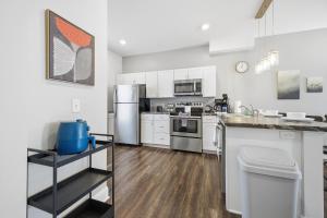 a kitchen with white cabinets and stainless steel appliances at Sun Valley Courtyard, No Steps in Saint Joseph