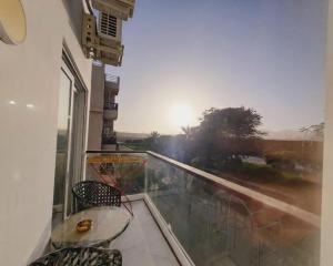 a balcony with a table and chairs and a view at Jasmine in Sharm El Sheikh +2 photos