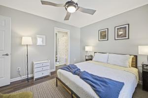 a bedroom with a bed and a ceiling fan at Sun Valley Loft, Close to Mosaic! in Saint Joseph