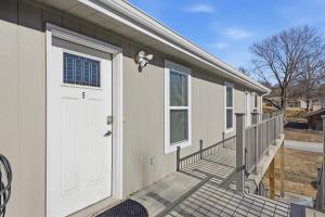 a house with a white door and a porch at Sun Valley Loft, Close to Mosaic! in Saint Joseph