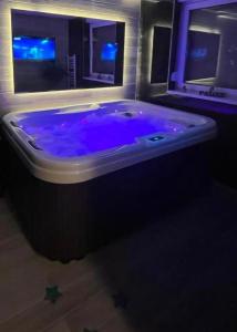 a large blue tub in a room with a window at BiO Kruce Seaview in Ulcinj
