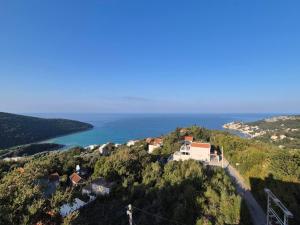a house on top of a hill next to the ocean at BiO Kruce Seaview in Ulcinj