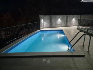 a swimming pool at night with lights on it at BiO Kruce Seaview in Ulcinj