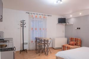 a living room with a table and a kitchen at Apartment Jursport in Závažná Poruba
