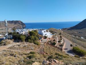 a village on a hill with the ocean in the background at La Virgen del Mar in Las Hortichuelas Bajas